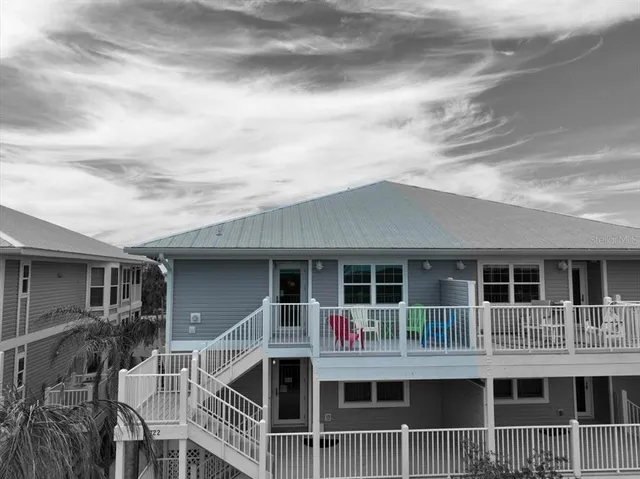 a living room with furniture a chandelier and a window
