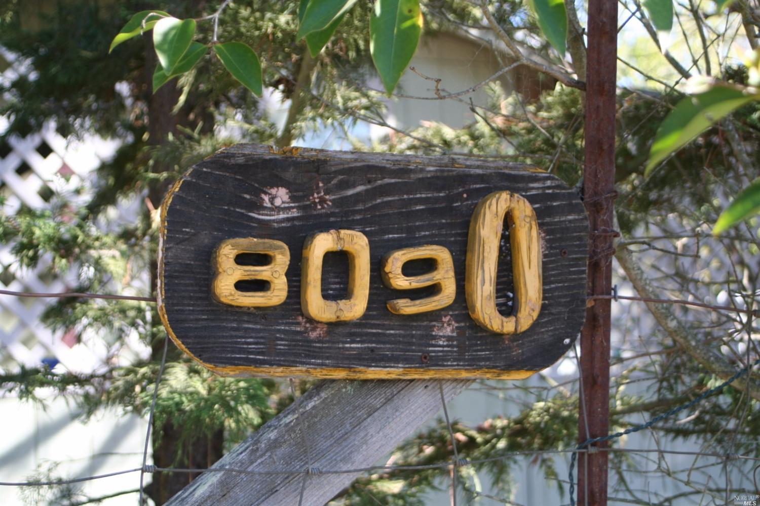 a wooden sign with a tree