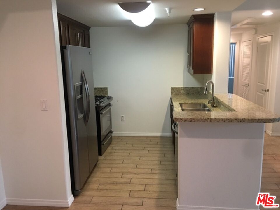 11925 Kling Street, Unit 311 Valley Village, CA 91607 - Photo 11 of 25 a bathroom with a sink a toilet and mirror