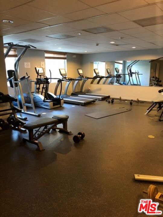 11925 Kling Street, Unit 311 Valley Village, CA 91607 - Photo 14 of 25 a room with gym equipment and a large window