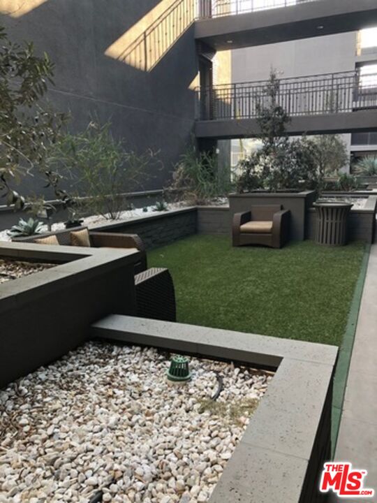 11925 Kling Street, Unit 311 Valley Village, CA 91607 - Photo 18 of 25 a view of a swimming pool with a patio