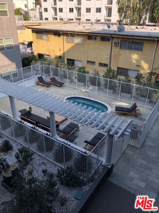 11925 Kling Street, Unit 311 Valley Village, CA 91607 - Photo 2 of 25 a view of a swimming pool with outdoor seating