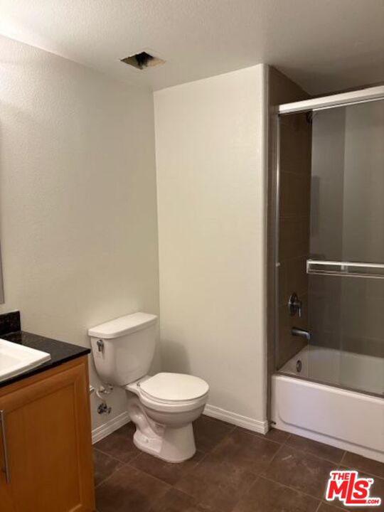 11925 Kling Street, Unit 311 Valley Village, CA 91607 - Photo 22 of 25 a white toilet sitting next to a bathtub