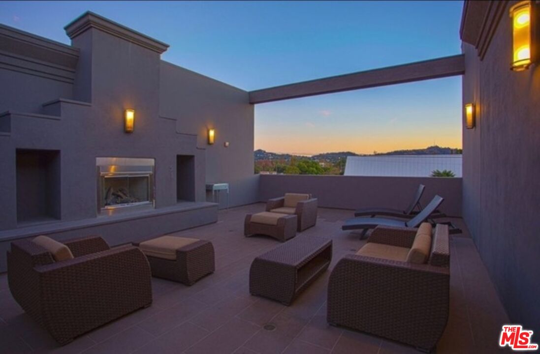 11925 Kling Street, Unit 311 Valley Village, CA 91607 - Photo 7 of 25 a living room with furniture and a flat screen tv