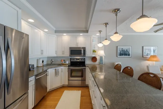 a living room with furniture a dining table and chairs with wooden floor