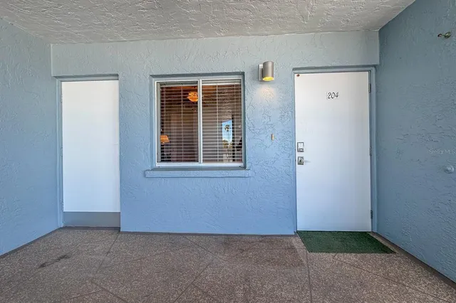 a living room with furniture and a lamp