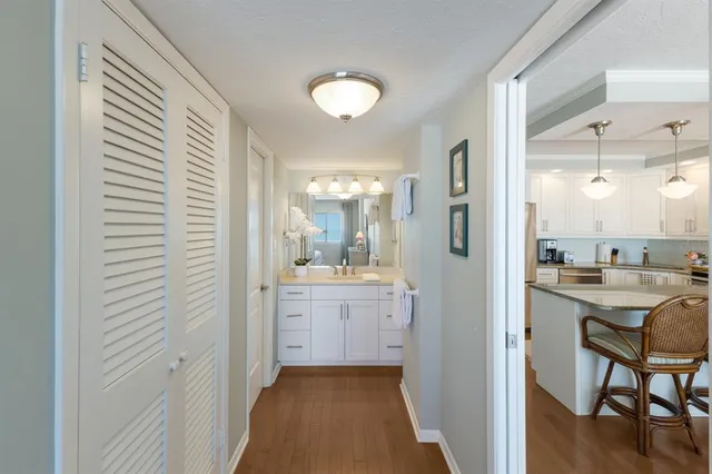 a bathroom with a sink a toilet and a large mirror