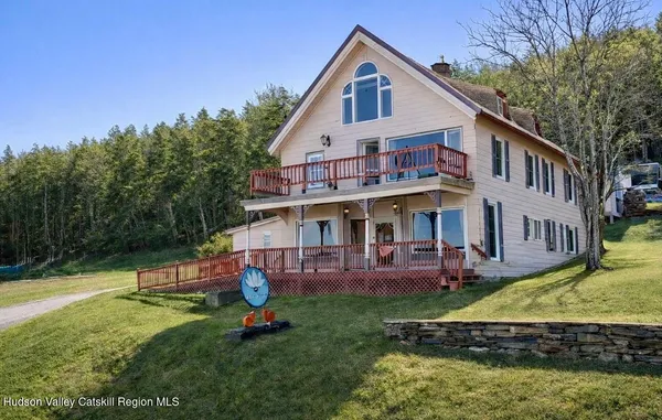 a view of a house with a yard patio and fire pit