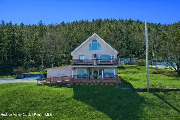 a view of house with outdoor space and yard