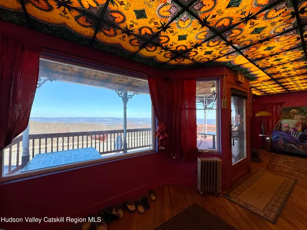 a view of a porch with furniture and a yard