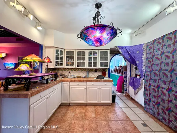 a kitchen that has a lot of cabinets and a wooden floor