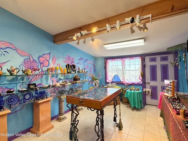 a view of a room with furniture wooden floor and windows