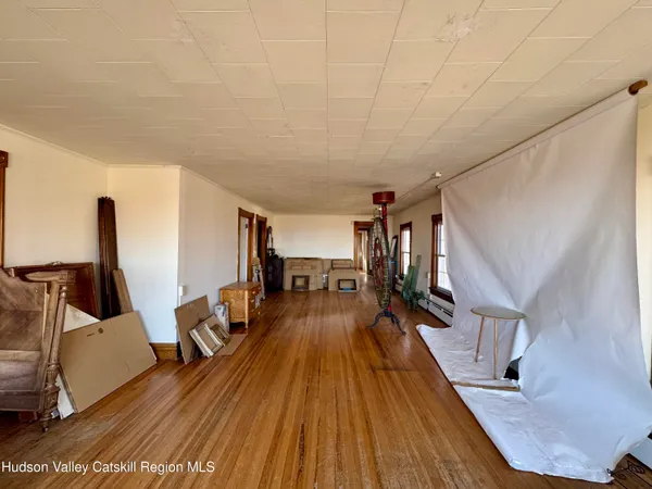 a living room with hard wood floors and a window