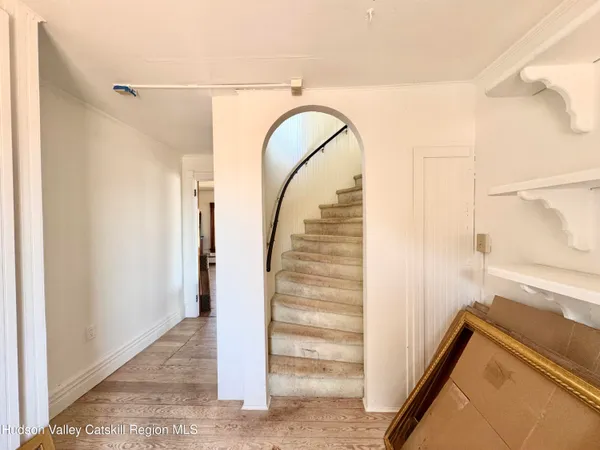 a living room with a fireplace windows and a fireplace
