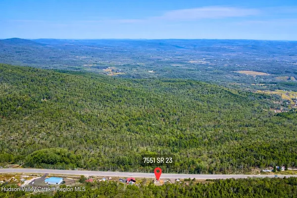 a view of a green field with lots of bushes