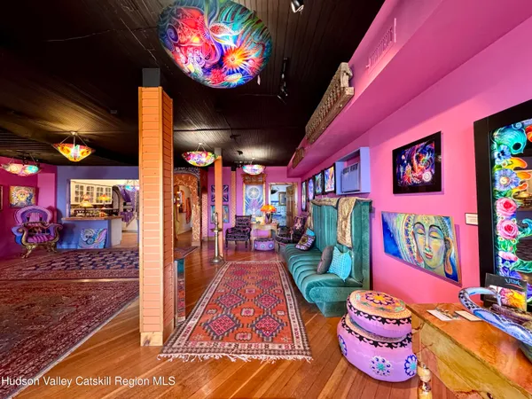 a living room with lots of furniture and lamp