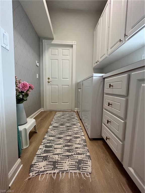 5477 Freeport Lane Naples, FL 34119 - Photo 22 of 36 a bedroom with a bed and a cabinets