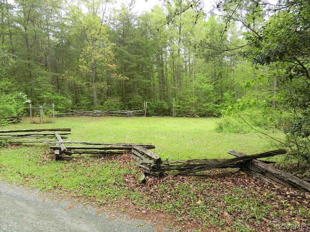 20801 Beaver Dam Road Beaverdam, VA 23015 - Photo 3 of 50 a view of a lake with a yard and trees