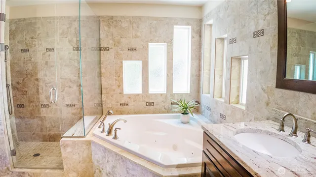 a bath tub sitting next to a bathroom sink