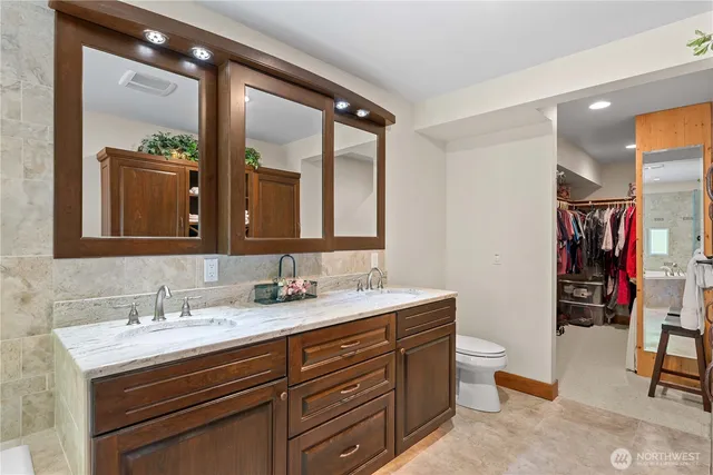 a bathroom with a toilet sink and mirror
