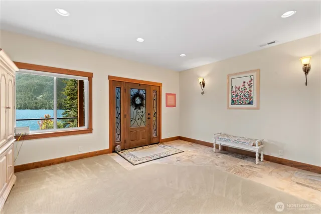 an empty room with furniture and a large window