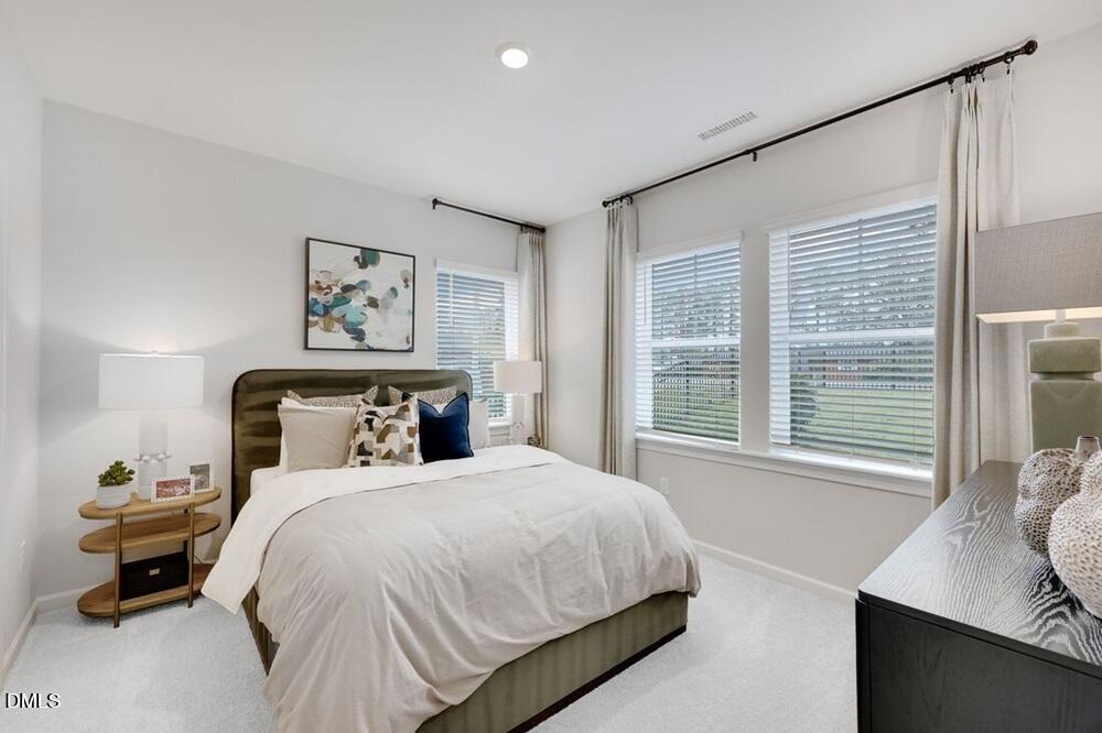 1324 West Garner Road, Unit 104 Garner, NC 27529 - Photo 19 of 23 a bedroom with a bed and a window