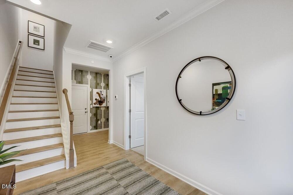 1324 West Garner Road, Unit 104 Garner, NC 27529 - Photo 7 of 23 a view of a hallway with wooden floor and entryway
