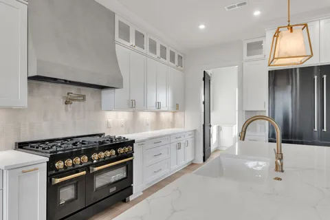 a kitchen with white cabinets and a sink