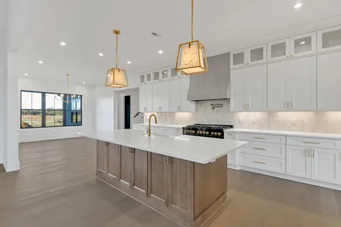 an empty room with windows and stairs