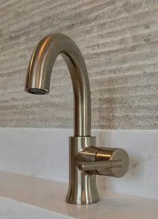 a bathroom with a granite countertop shower and a sink