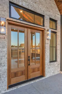 a view of large kitchen with granite countertop a large counter top stainless steel appliances and cabinets