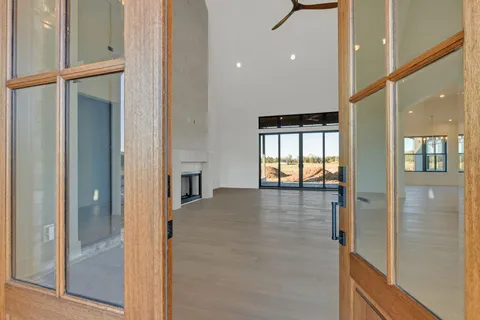 a view of a kitchen with a sink and a large window