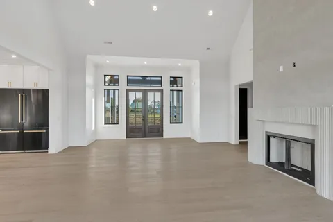 a bathroom with a glass door shower and mirror