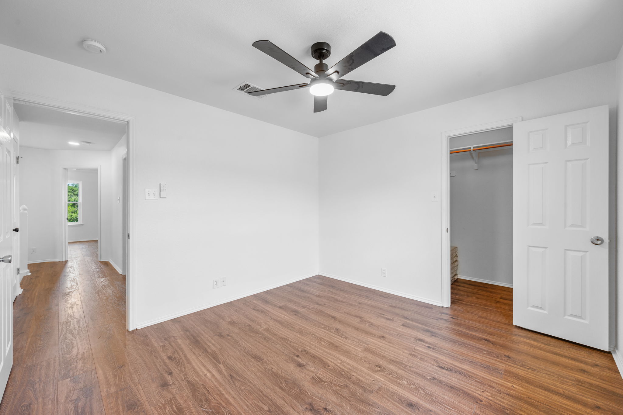 2440 Madeline Loop Cedar Park, TX 78613 - Photo 25 of 33 Unfurnished bedroom featuring a spacious closet, dark wood-style flooring, and ceiling fan