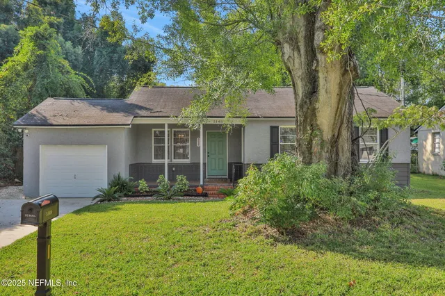a front view of a house with garden