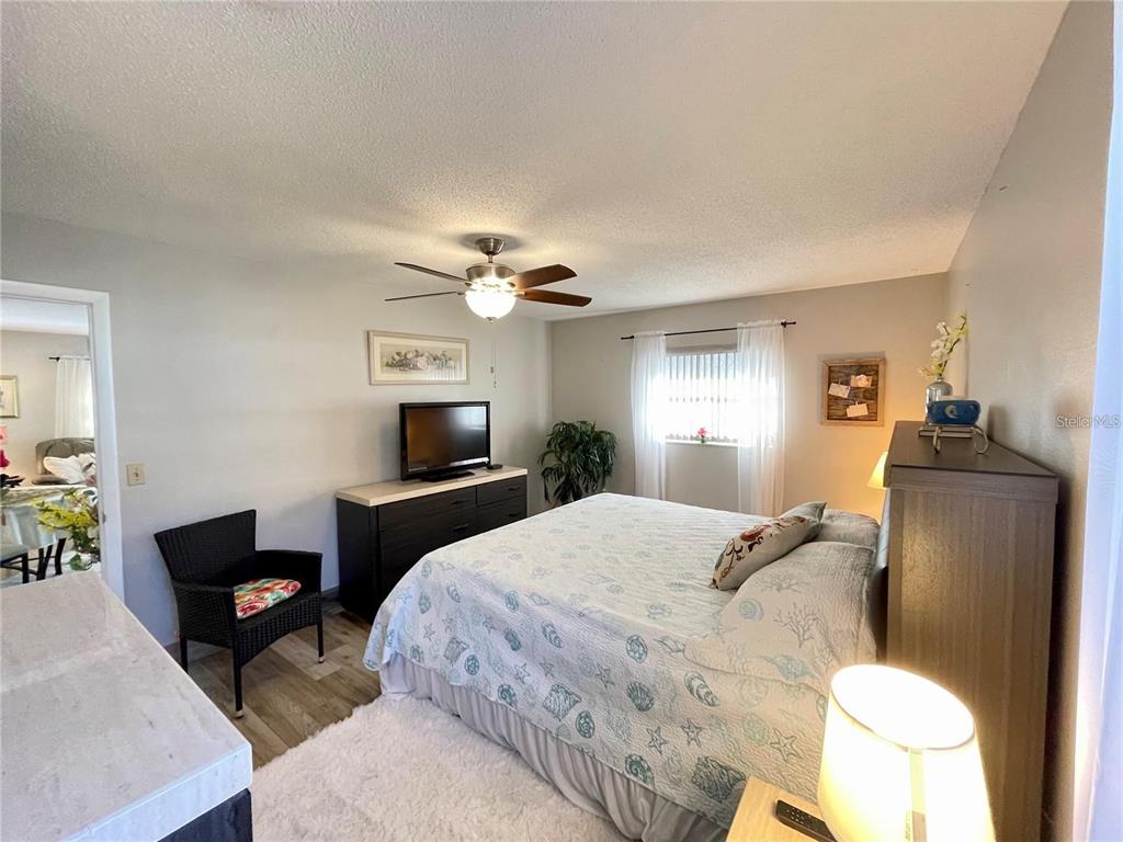 3495 Tree Line Court, Unit 8 Sarasota, FL 34231 - Photo 21 of 40 a bedroom with a bed and a flat screen tv