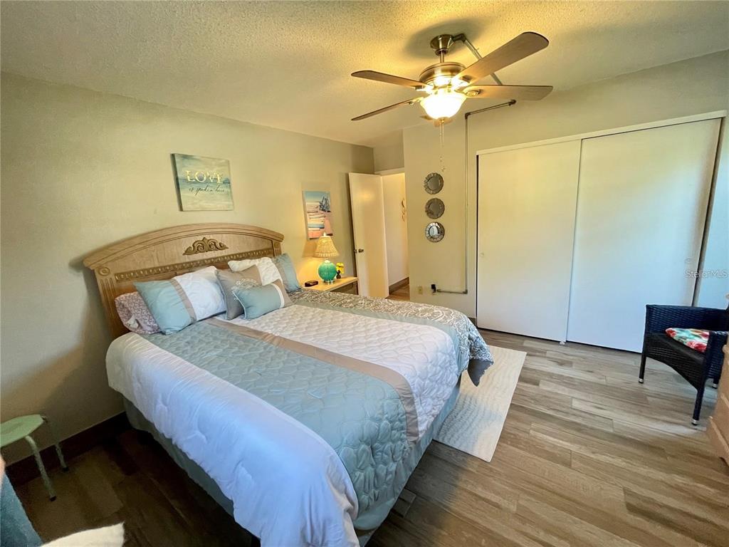3495 Tree Line Court, Unit 8 Sarasota, FL 34231 - Photo 32 of 40 a bedroom with a bed chandelier and a window