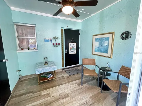 a workspace with wooden floor and a ceiling fan