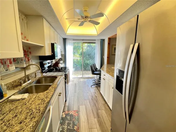 a kitchen with a refrigerator a sink a stove and a refrigerator