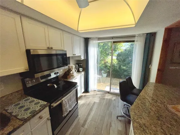 a kitchen with a stove a sink and a microwave