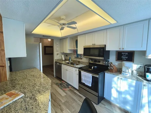 a kitchen with stainless steel appliances granite countertop a stove sink and cabinets