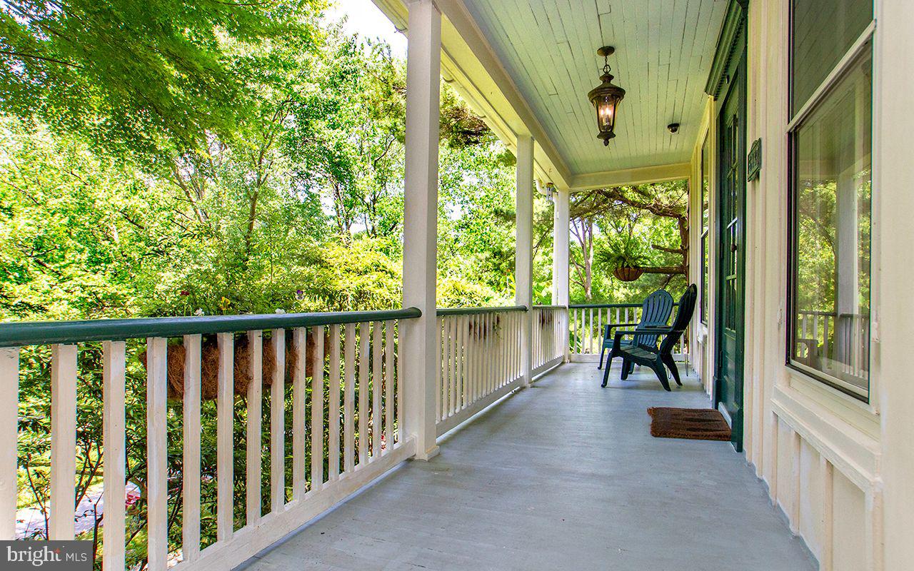 5137 Wetheredsville Road Baltimore, MD 21207 - Photo 8 of 89 a view of a porch with chairs and wooden fence