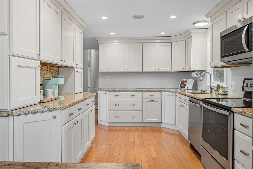 3 Nantucket Avenue Swampscott, MA 01907 - Photo 14 of 41 a kitchen with granite countertop a sink a stove and cabinets