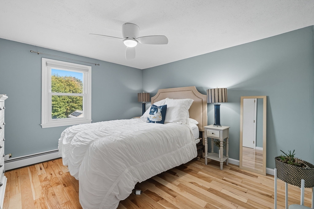 3 Nantucket Avenue Swampscott, MA 01907 - Photo 17 of 41 a bedroom with a bed and a chandelier