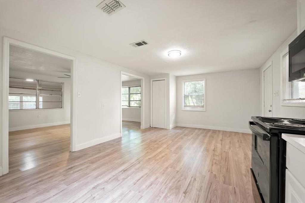 7903 New Kings Road Jacksonville, FL 32219 - Photo 12 of 28 an empty room with wooden floor and windows