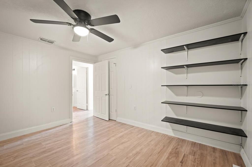 7903 New Kings Road Jacksonville, FL 32219 - Photo 16 of 28 an empty room with wooden floor closet and windows