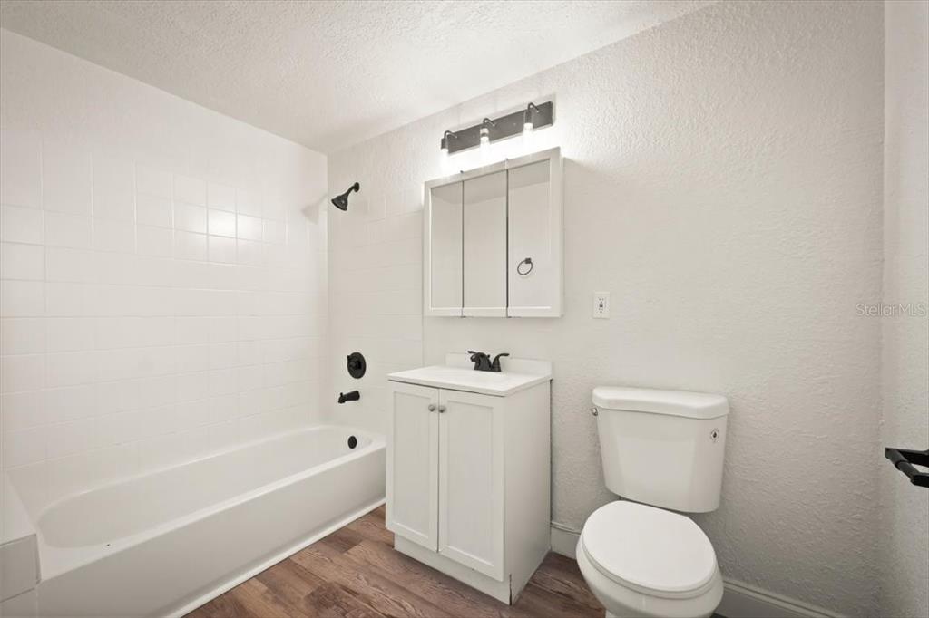 7903 New Kings Road Jacksonville, FL 32219 - Photo 24 of 28 a bathroom with a toilet a sink a mirror and bathtub