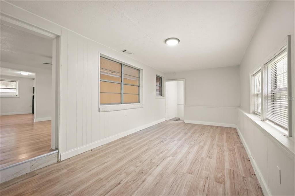 7903 New Kings Road Jacksonville, FL 32219 - Photo 4 of 28 an empty room with wooden floor and windows
