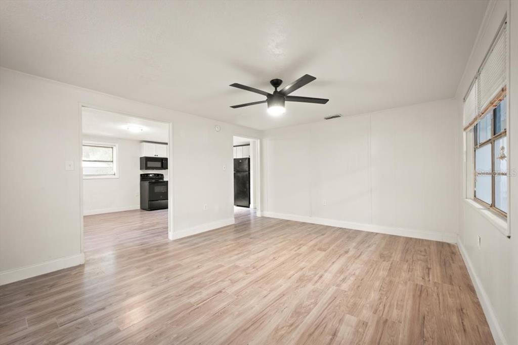 7903 New Kings Road Jacksonville, FL 32219 - Photo 5 of 28 a view of an empty room with a window and wooden floor