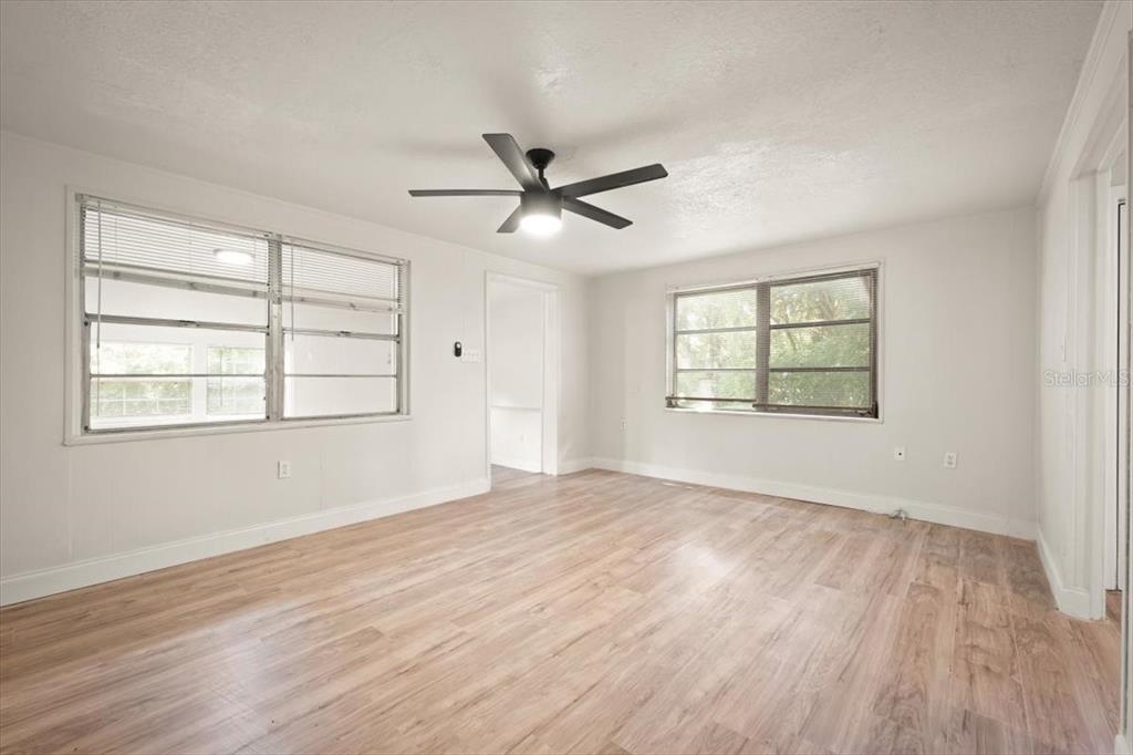 7903 New Kings Road Jacksonville, FL 32219 - Photo 7 of 28 wooden floor in an empty room with a window